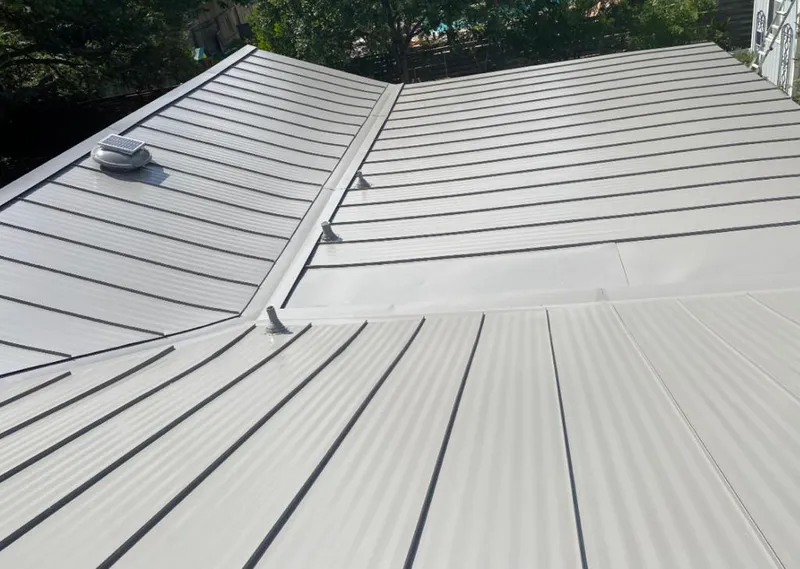 Solar attic fan installed on a metal roof for Roof Ventilation in Saratoga Springs